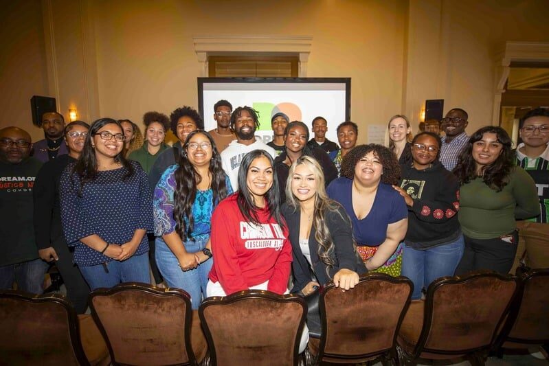 A group of Justice Next Cohort members smiling for the photo