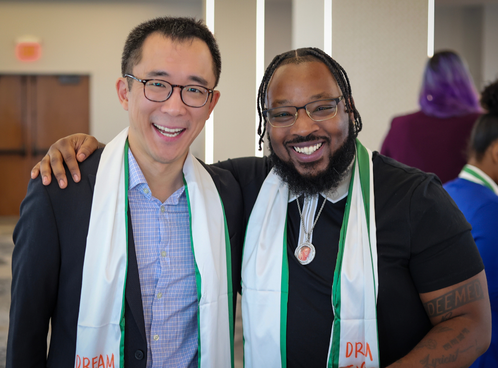 Two Dream Justice Cohort graduates smiling and posing for a photo.